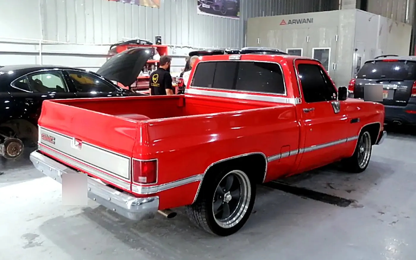 Restored Chevrolet C10 pickup in red, seen from the rear