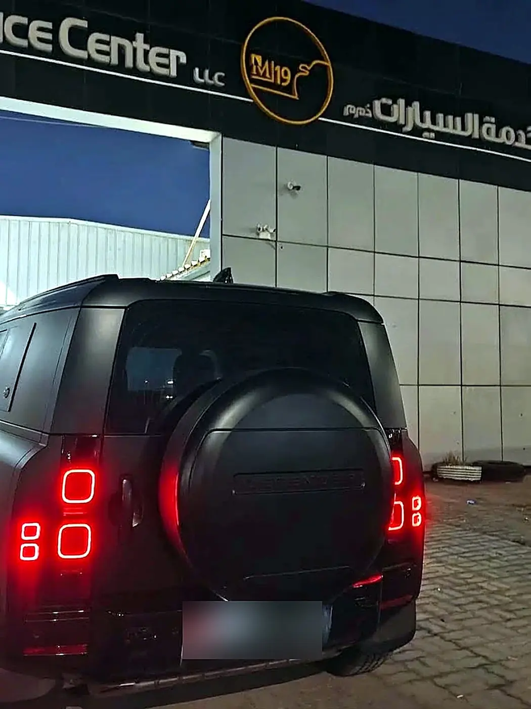 Defender parked outside the M19 shopfront at night