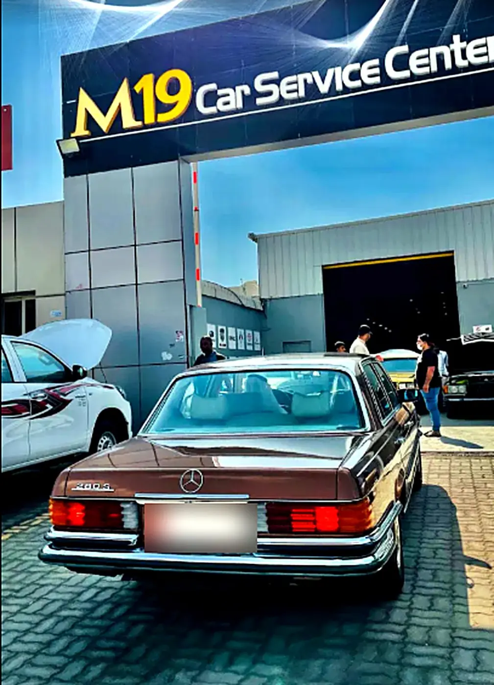 Classic Mercedes 280 SE parked outside the M19 shopfront