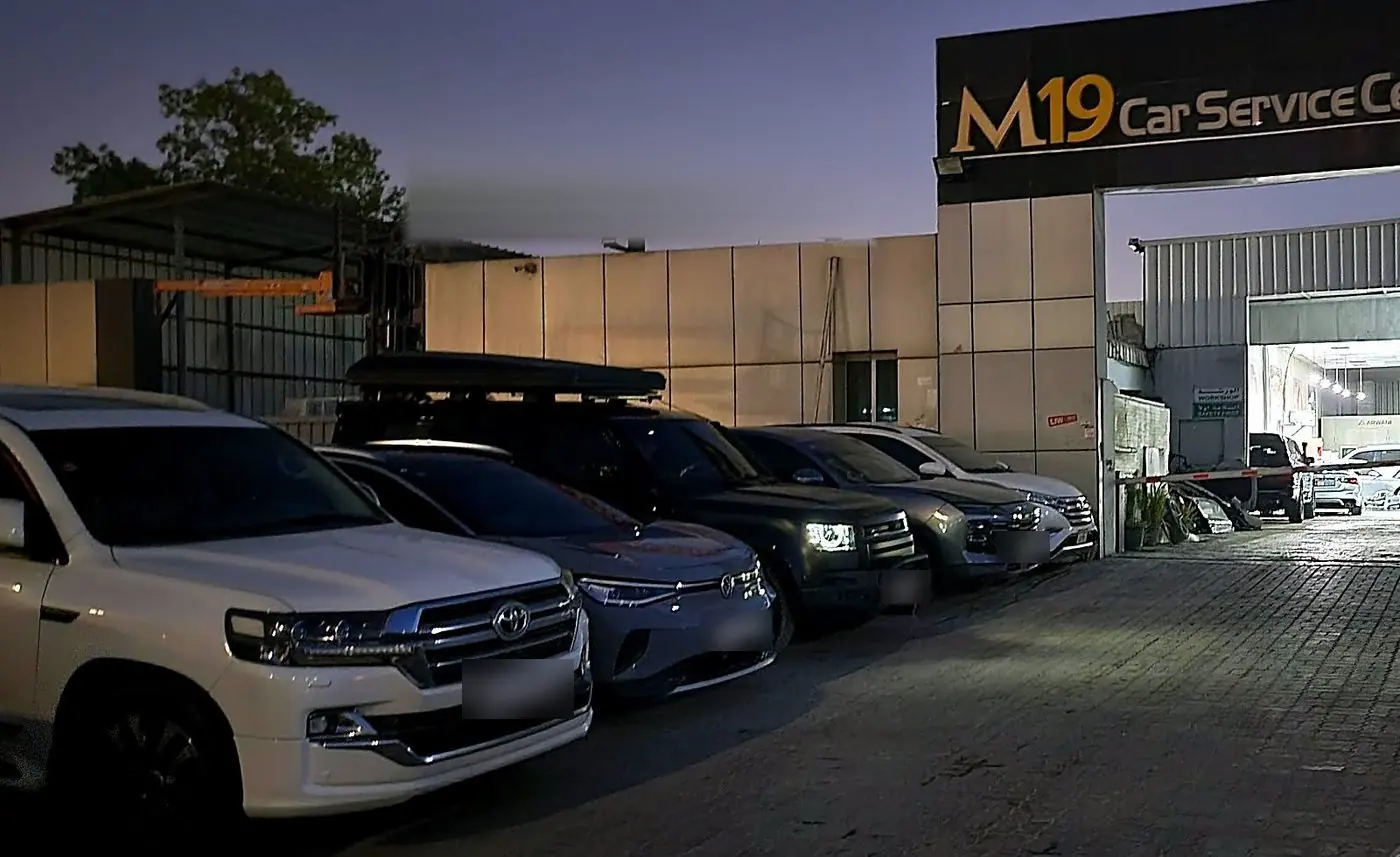 M19 Car Service Center shopfront in Mussafah at dusk